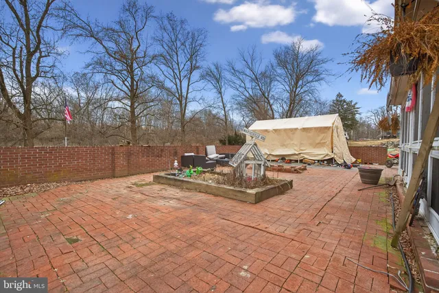 a view of a house with a wooden floor and a yard