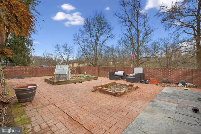 a view of house with backyard and outdoor seating