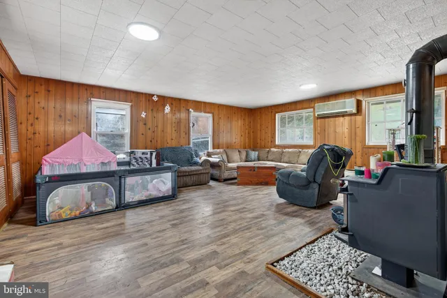 a living room with furniture a large window and flat screen tv