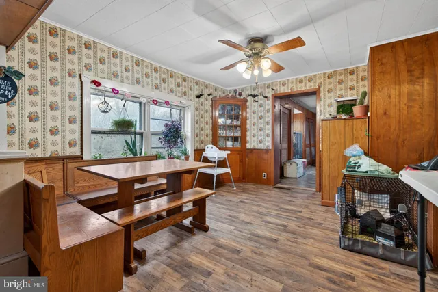 a living room with furniture a dining table and a fireplace