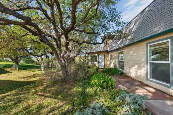 a view of a patio with table and chairs under an umbrella