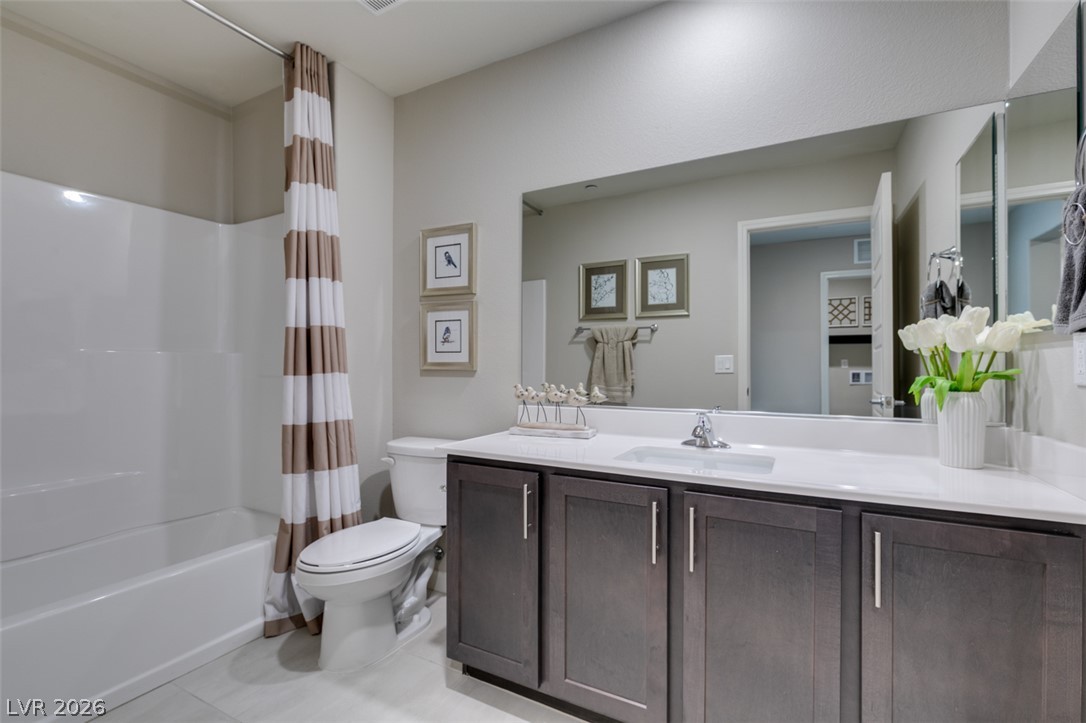 653 Pickled Pepper Place Henderson, NV 89011 - Photo 23 of 35 A well-appointed bath features a spacious vanity and a tub with a shower for daily comfort.