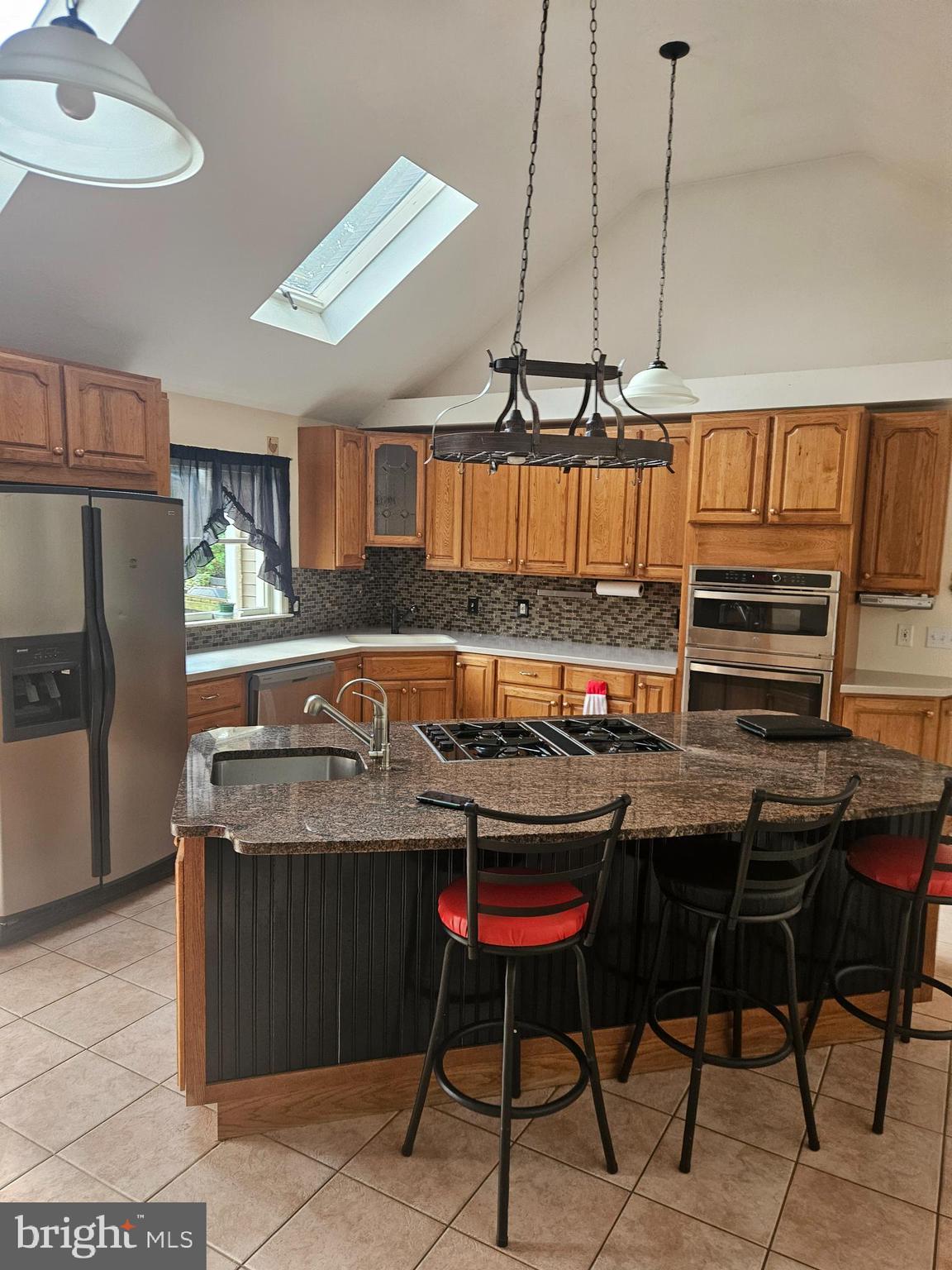 333 Newcomer Road Windsor, PA 17366 - Photo 3 of 25 a kitchen with stainless steel appliances granite countertop a stove a sink refrigerator and cabinets