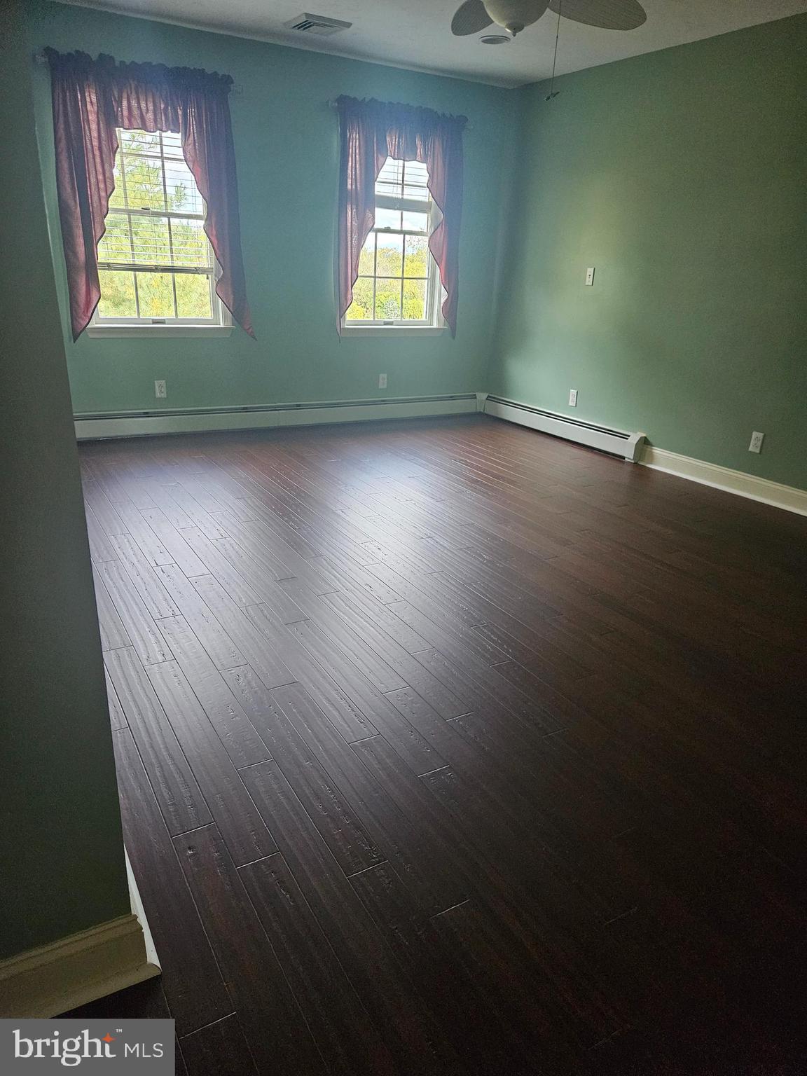 333 Newcomer Road Windsor, PA 17366 - Photo 4 of 25 an empty room with wooden floor and windows