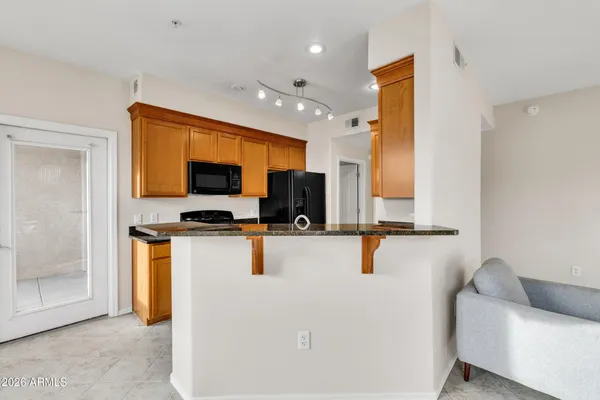 a dining room with furniture a window and a kitchen view