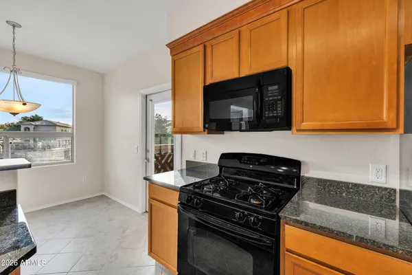 a kitchen with a sink a refrigerator and cabinets