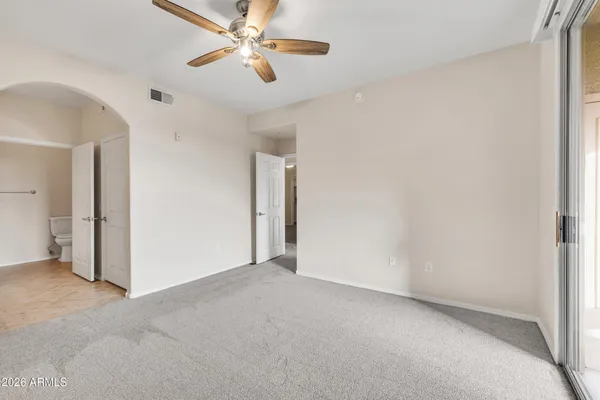 a en suite bathroom with a granite countertop sink and a mirror