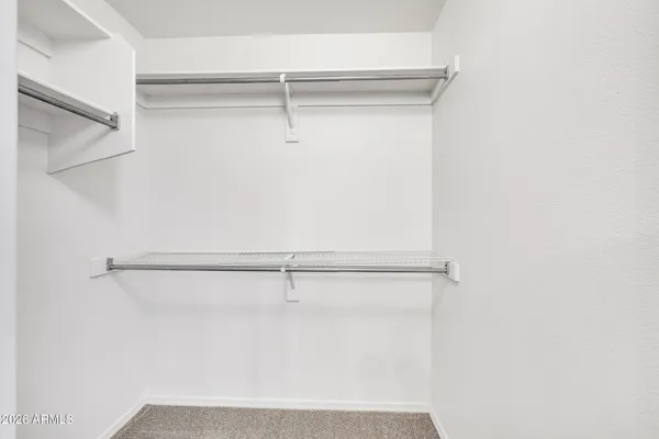 a view of an empty room with a ceiling fan