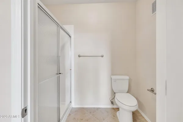 a bathroom with a shower sink and mirror
