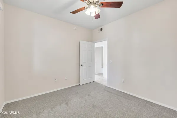 an empty room with closet and windows