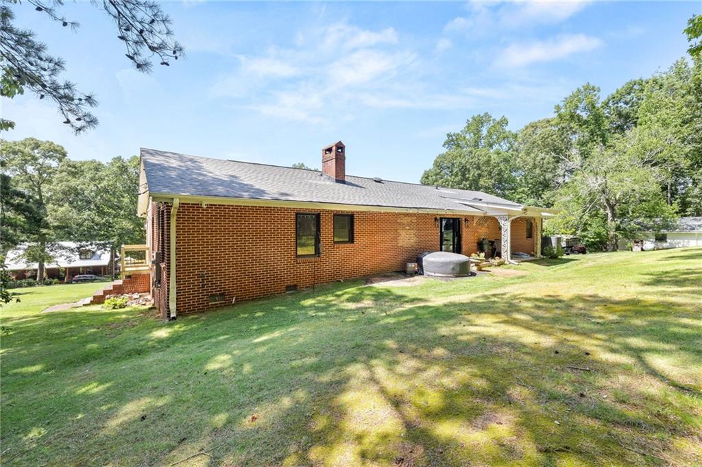 6470 Samoa Way Flowery Branch, GA 30542 - Photo 57 of 61 a front view of house with yard and trees in the background