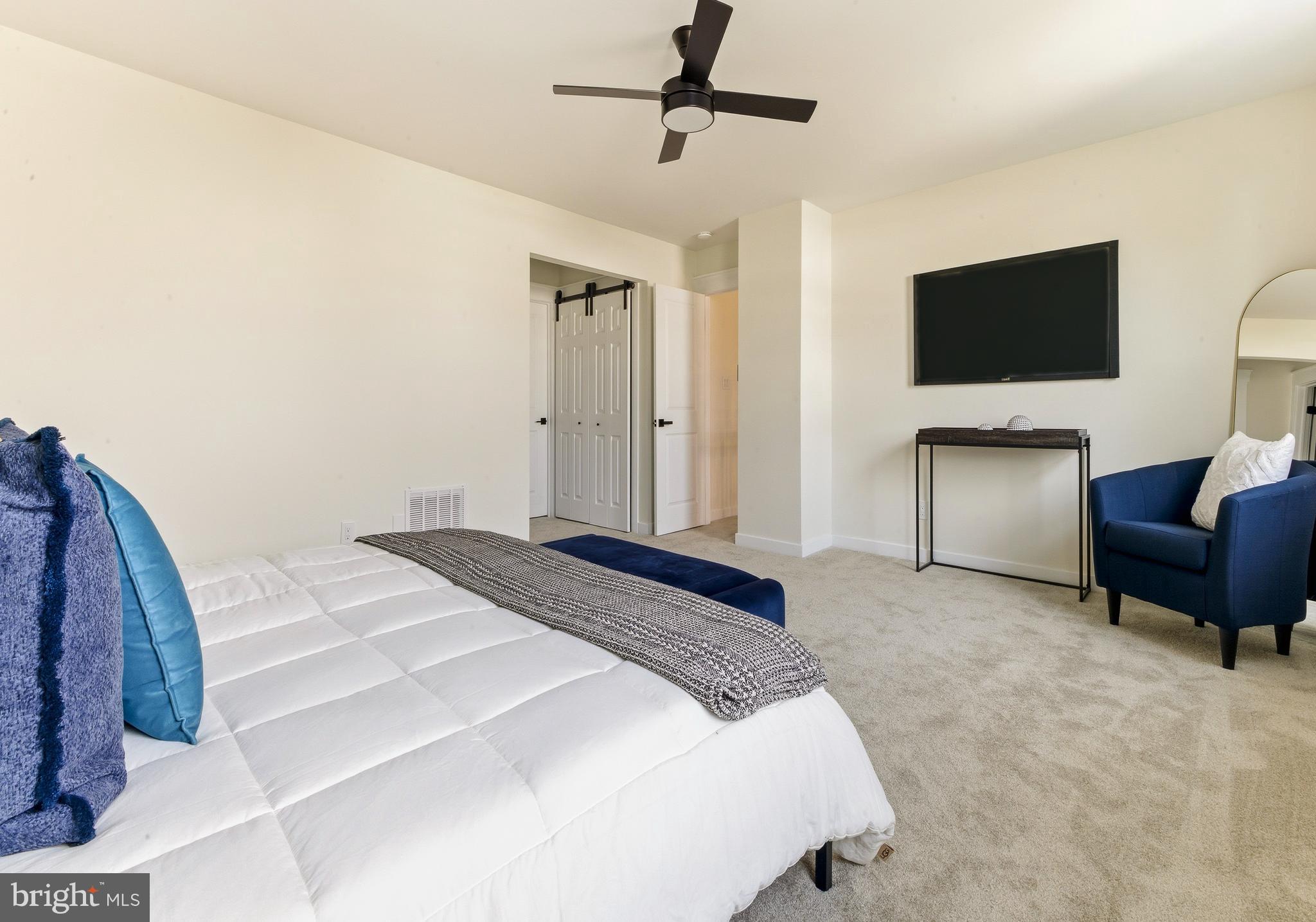 8 Michele Court Sewell, NJ 08080 - Photo 16 of 29 a bedroom with a bed flat screen tv and couches