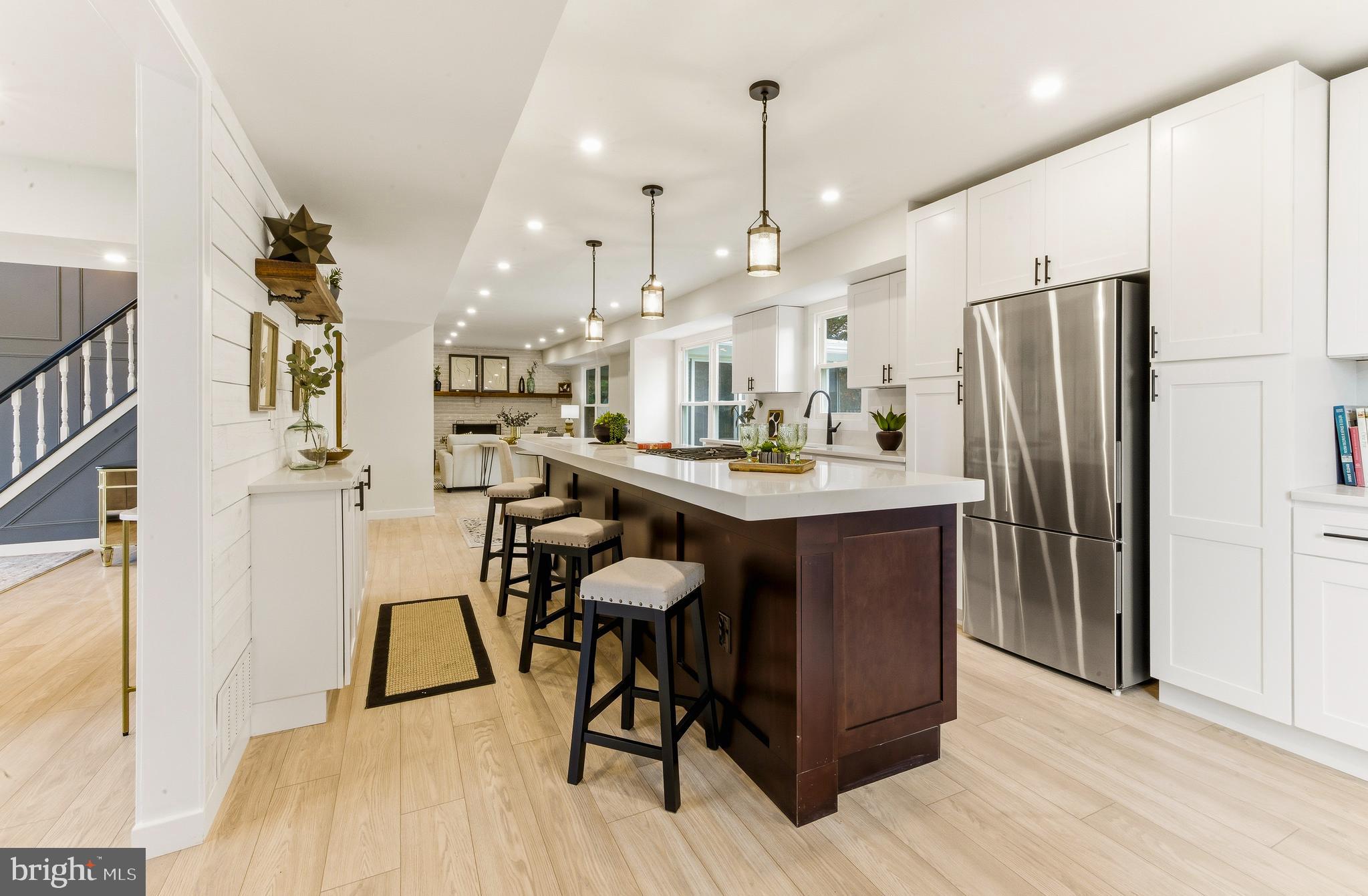 8 Michele Court Sewell, NJ 08080 - Photo 9 of 29 a kitchen with stainless steel appliances kitchen island granite countertop a refrigerator a stove a sink and a dining table with wooden floor