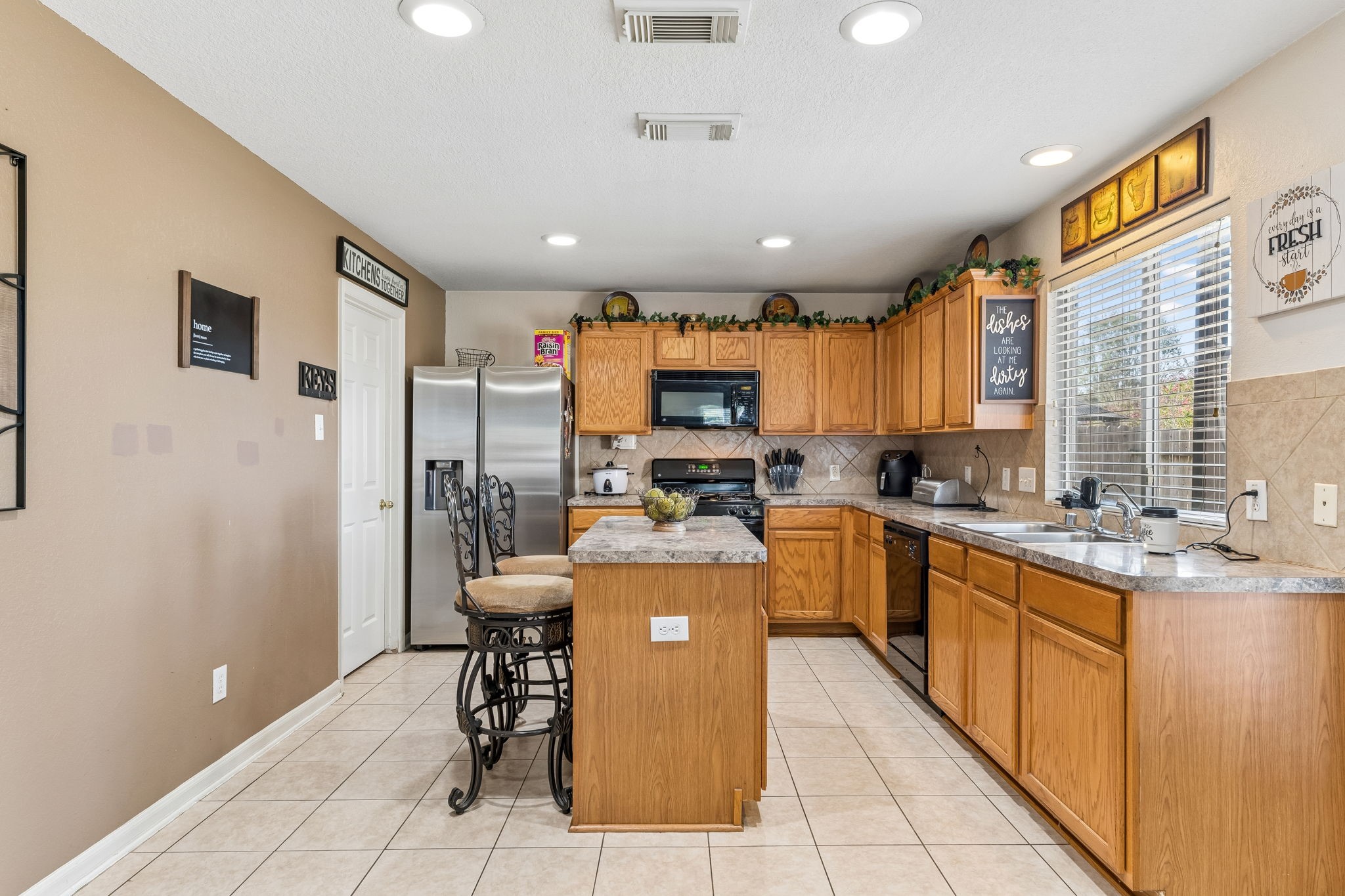 3203 Falcon Trail Drive Spring, TX 77373 - Photo 15 of 33 Well-designed kitchen with a center island, breakfast seating and plenty of cabinet and counter space. Convenient access to the utility room just off the kitchen.