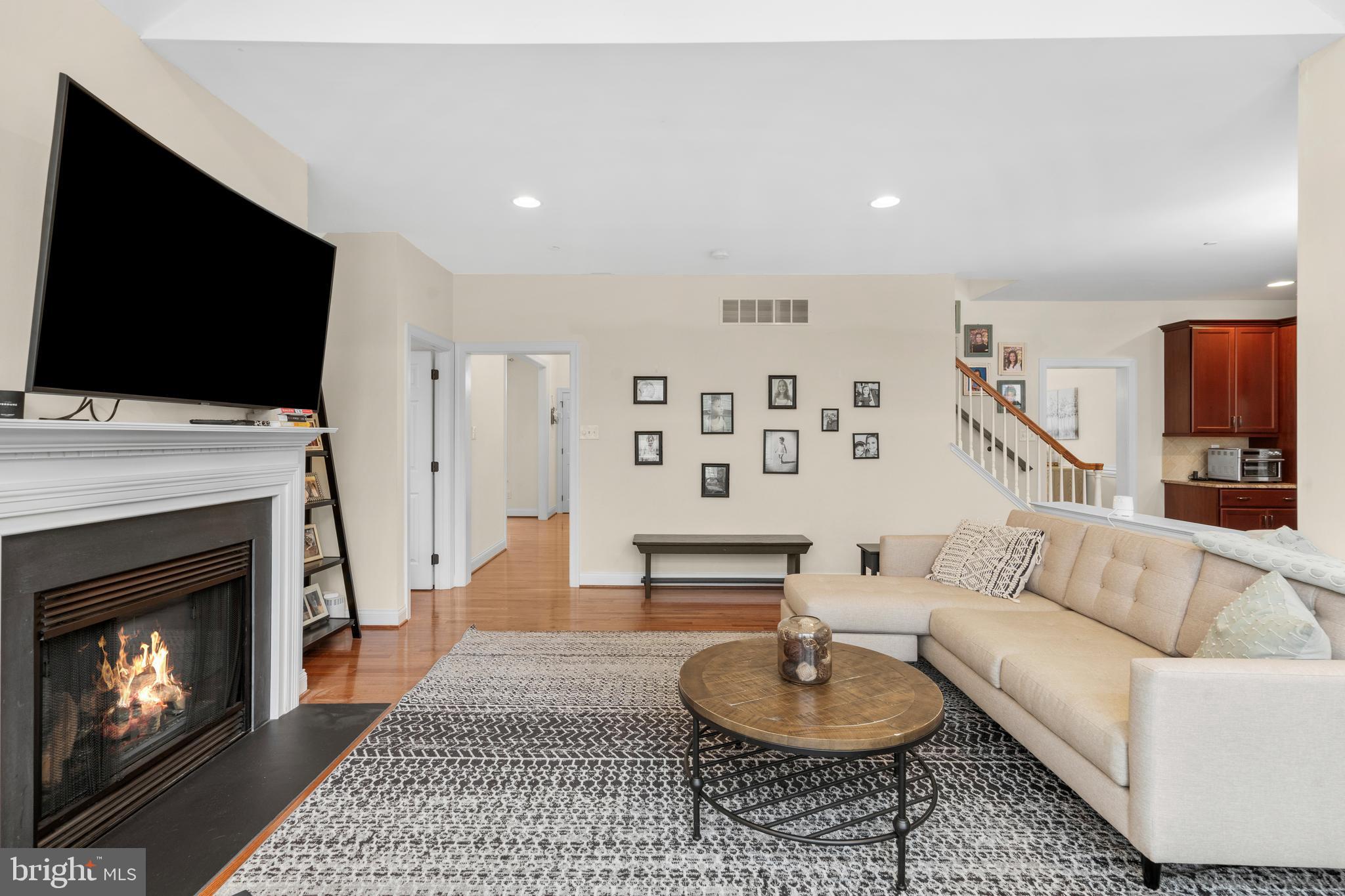 776 Barry Drive Springfield, PA 19064 - Photo 11 of 44 a living room with furniture a flat screen tv and a fireplace