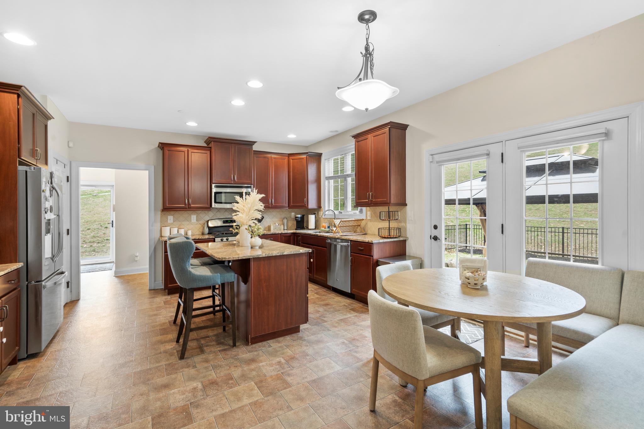 776 Barry Drive Springfield, PA 19064 - Photo 13 of 44 a kitchen with kitchen island a dining table and chairs