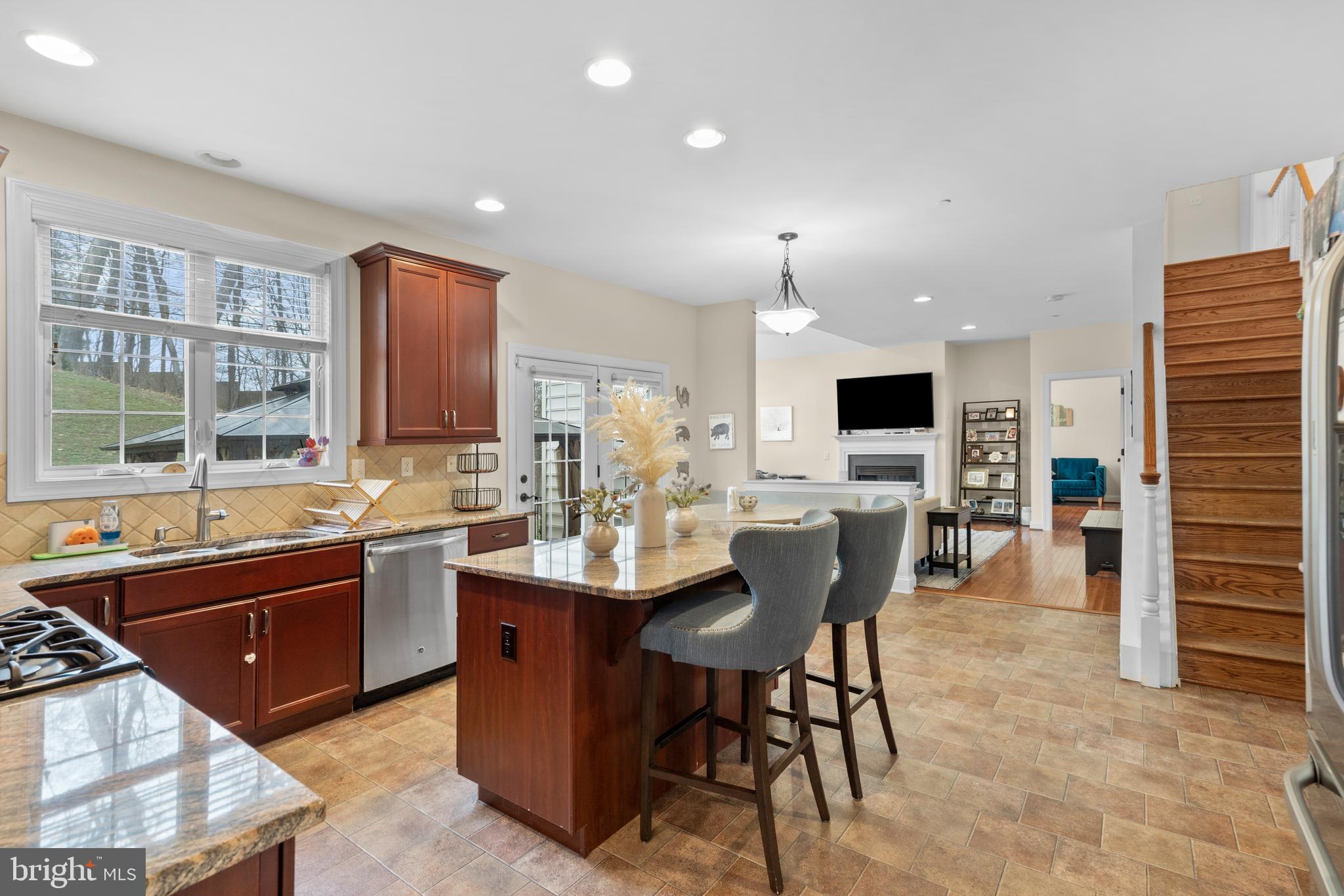 776 Barry Drive Springfield, PA 19064 - Photo 15 of 44 a kitchen with stainless steel appliances kitchen island granite countertop a sink and cabinets