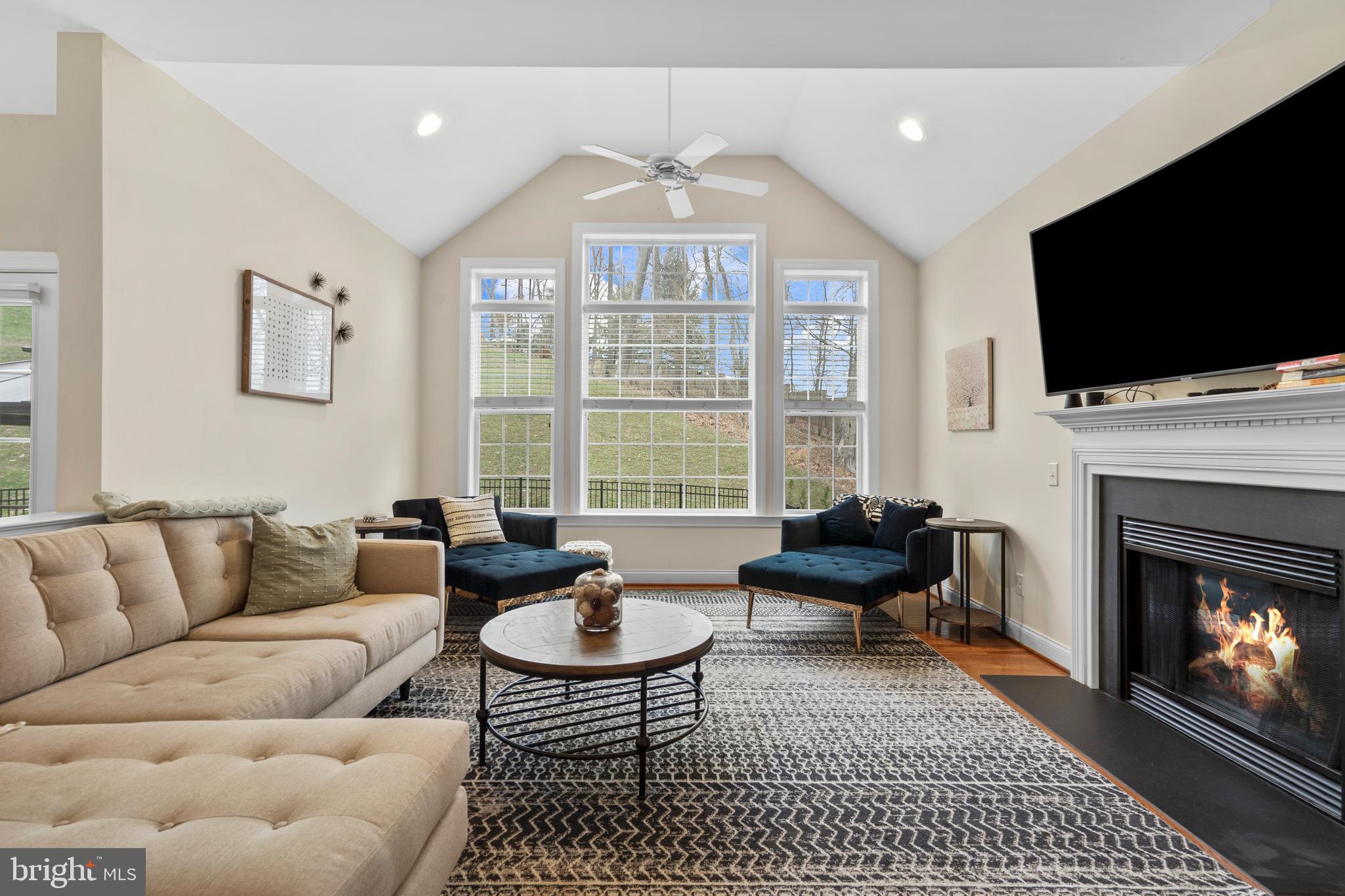 776 Barry Drive Springfield, PA 19064 - Photo 10 of 44 a living room with furniture a flat screen tv and a fireplace