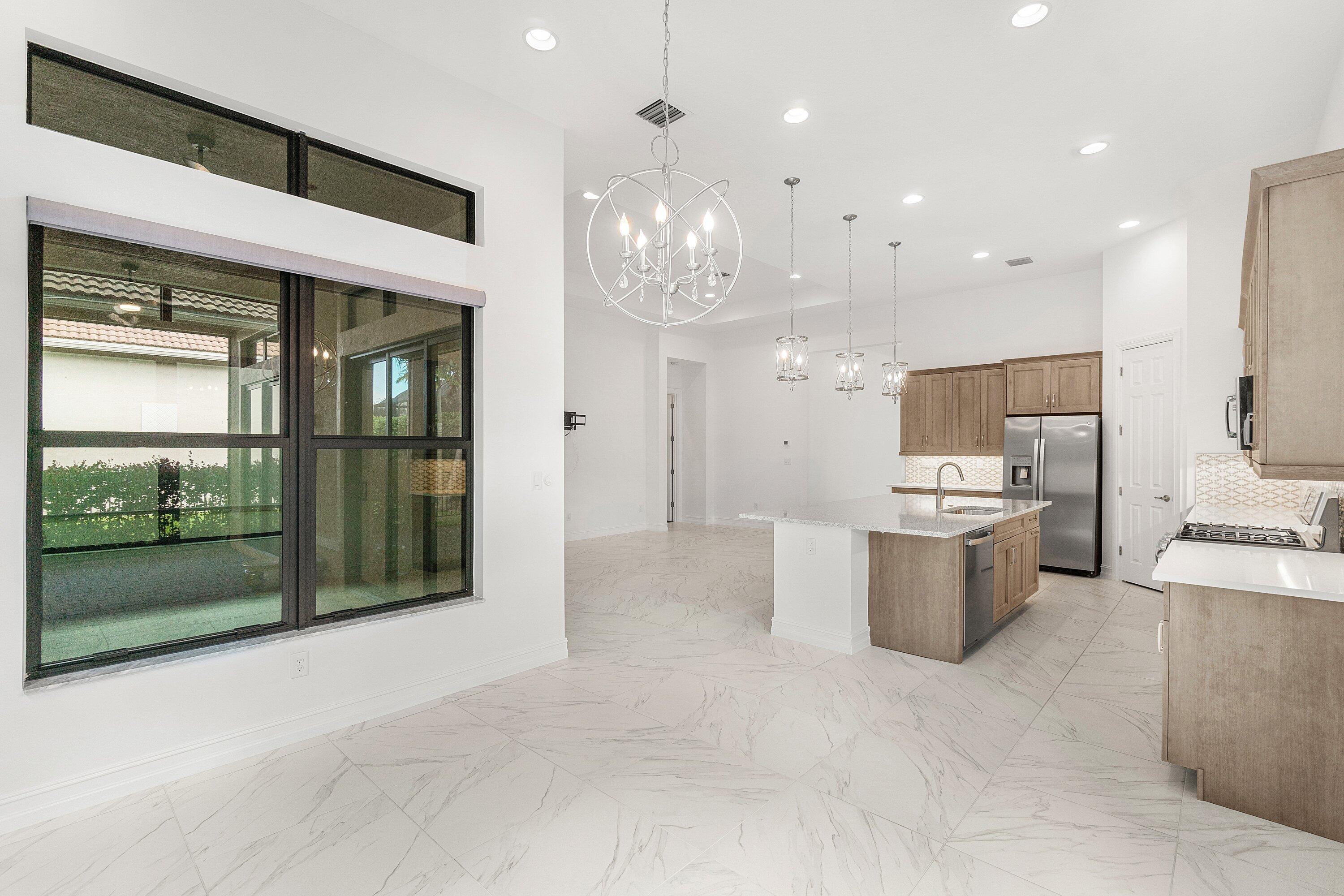11902 Palermo Road Parkland, FL 33076 - Photo 12 of 48 a view of a kitchen with refrigerator and mirror