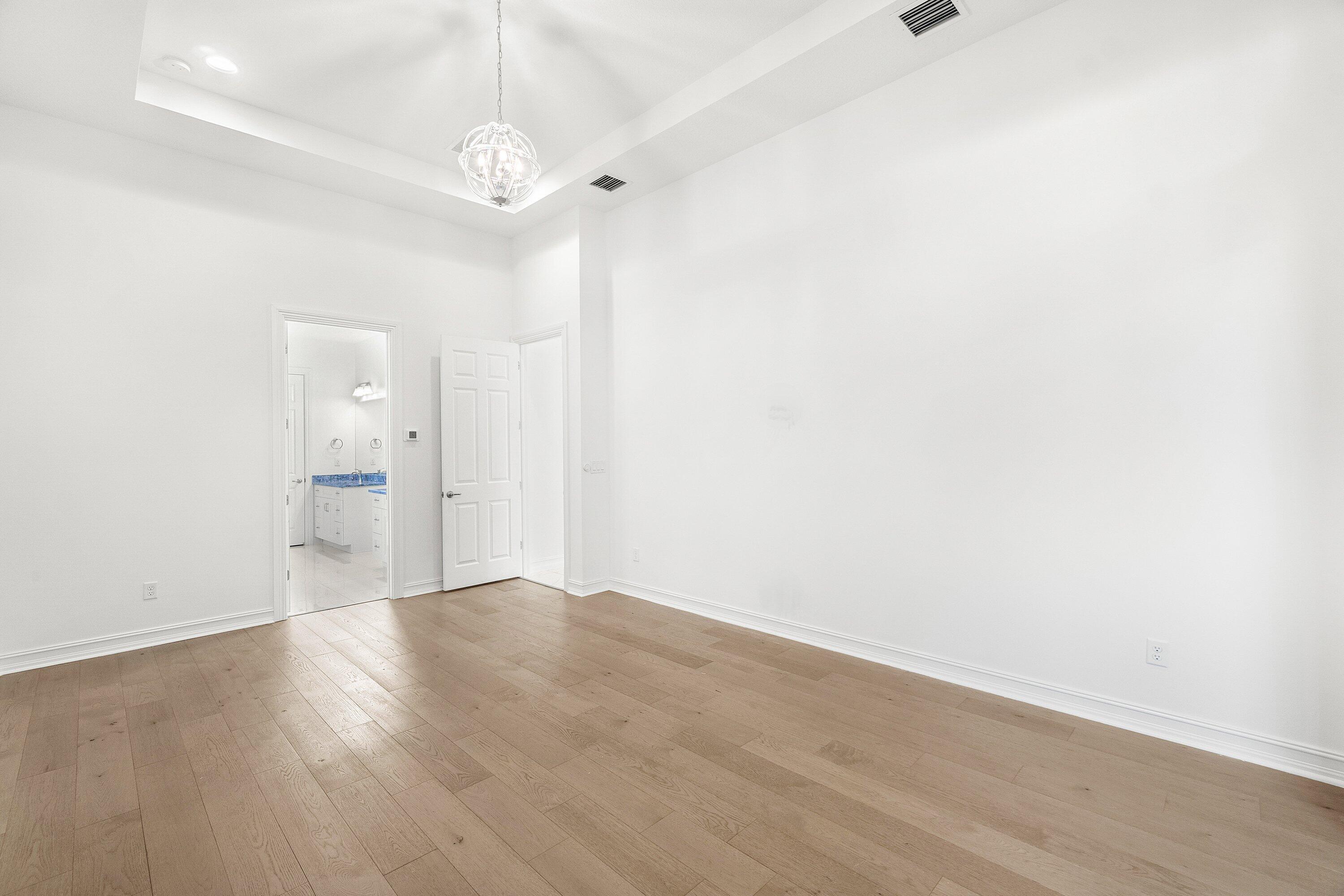 11902 Palermo Road Parkland, FL 33076 - Photo 17 of 48 a view of an empty room with wooden floor