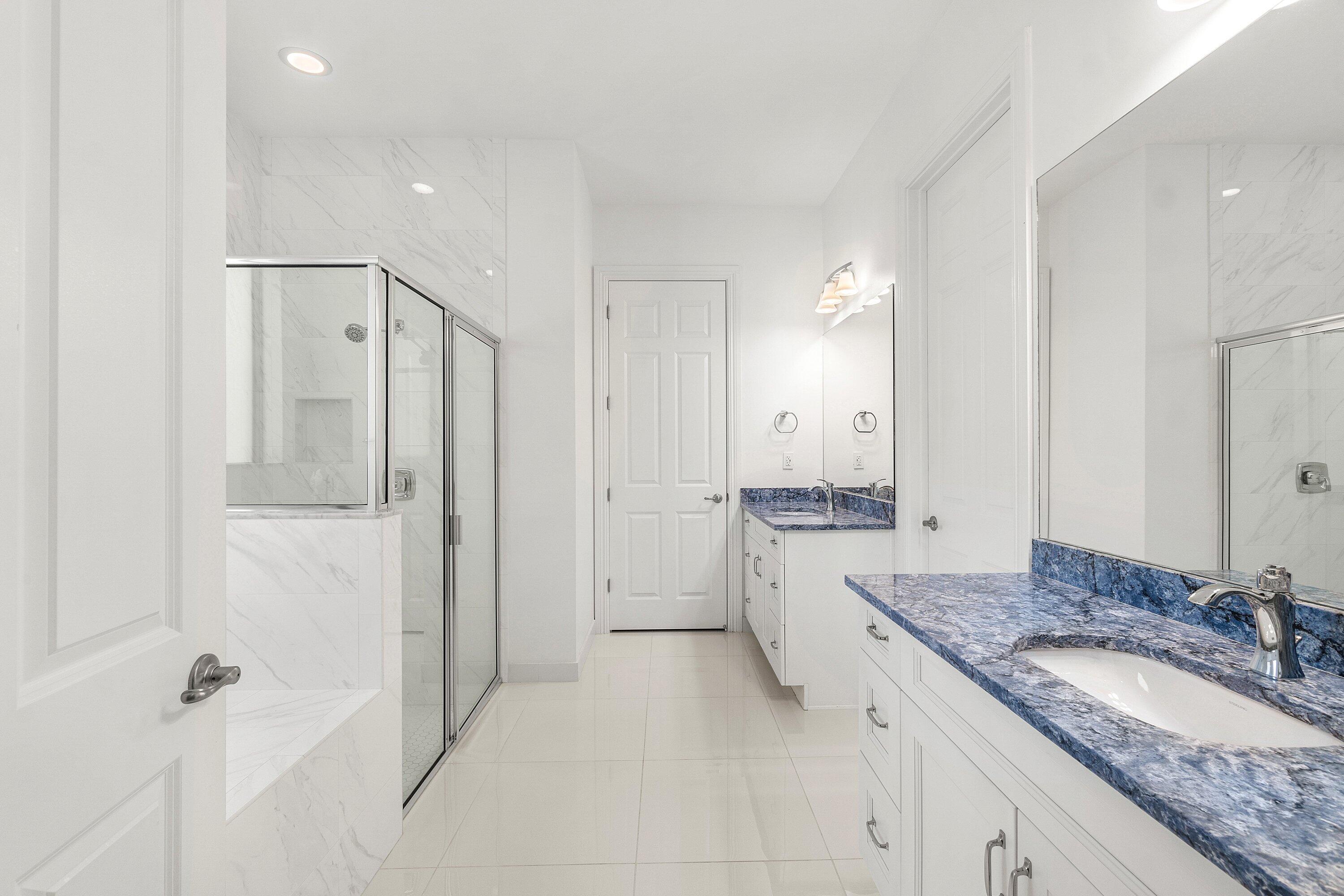 11902 Palermo Road Parkland, FL 33076 - Photo 19 of 48 a bathroom with a granite countertop sink mirror and a shower