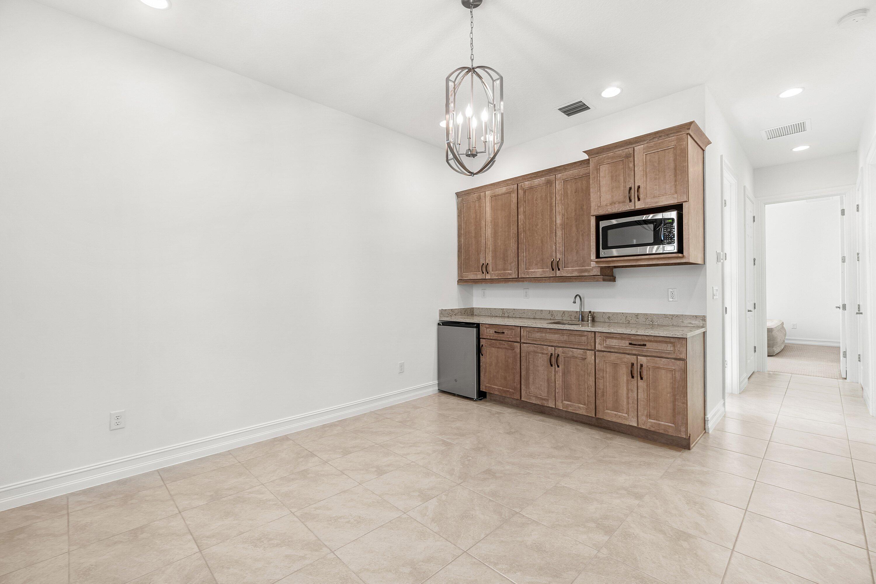 11902 Palermo Road Parkland, FL 33076 - Photo 28 of 48 a large kitchen with cabinets stainless steel appliances and a counter top