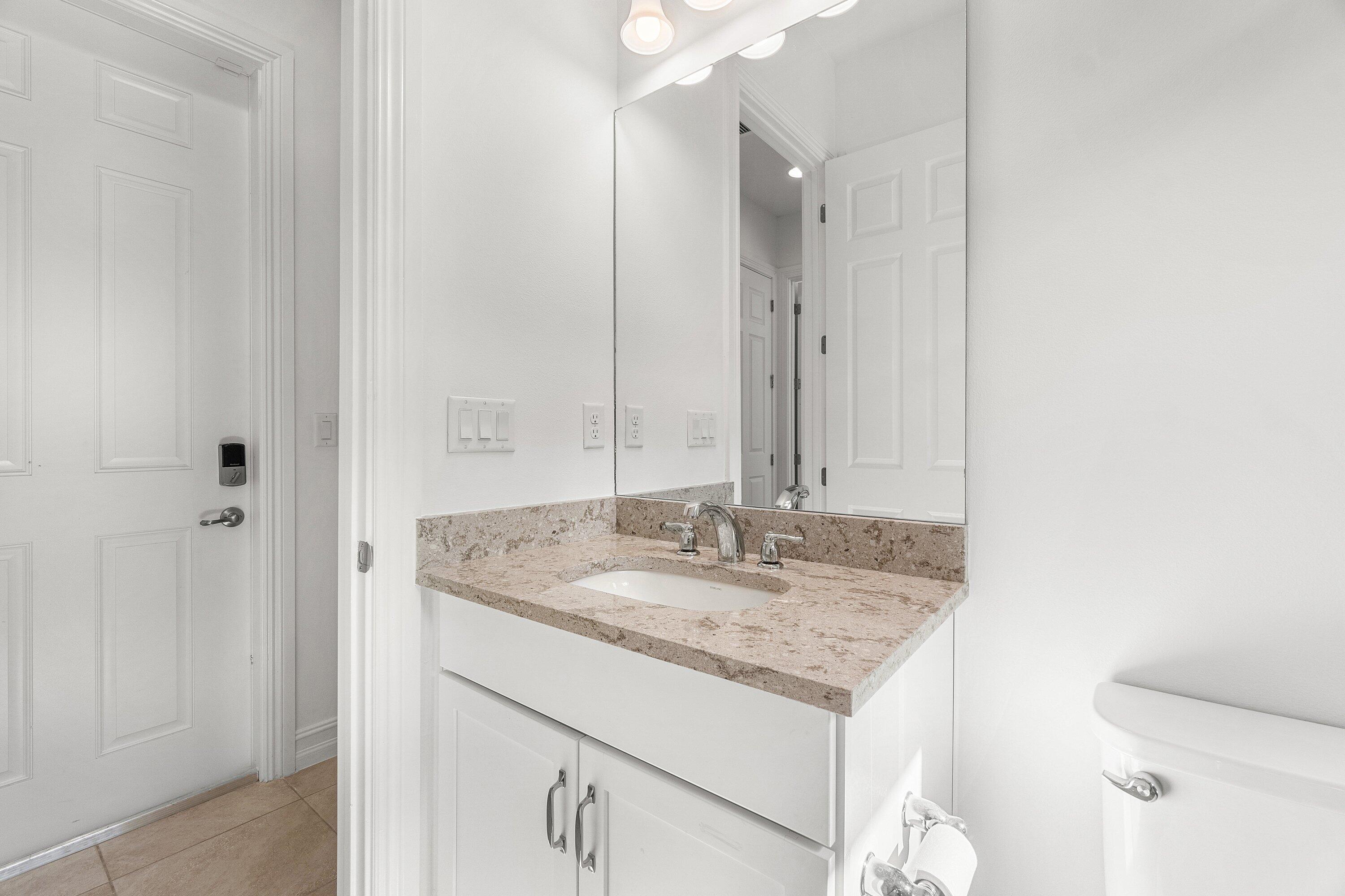 11902 Palermo Road Parkland, FL 33076 - Photo 34 of 48 a bathroom with a granite countertop sink and a mirror