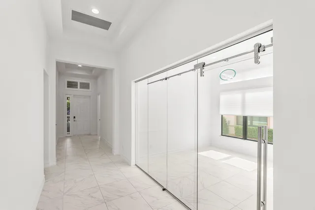 a view of a kitchen with refrigerator and mirror