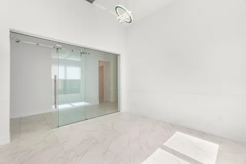 a bathroom with a granite countertop sink mirror and a shower