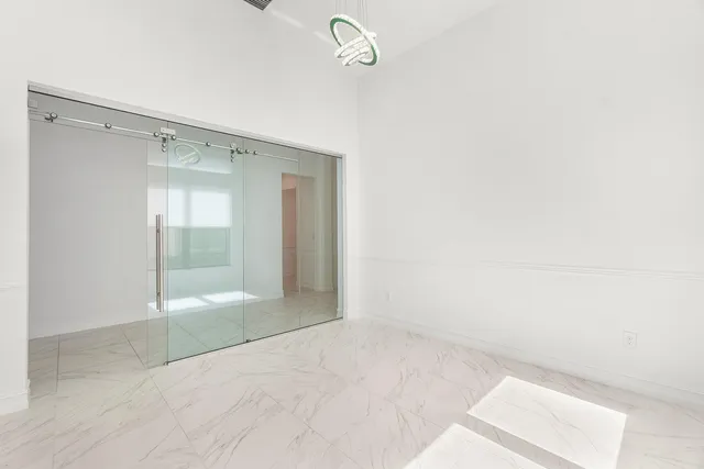 a view of a kitchen with large windows