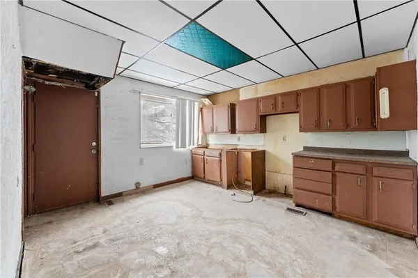 a kitchen with granite countertop a sink cabinets and stainless steel appliances