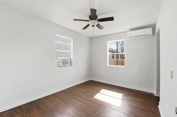 wooden floor in an empty room with a window