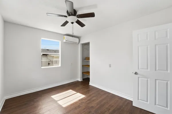 wooden floor in an empty room with a window