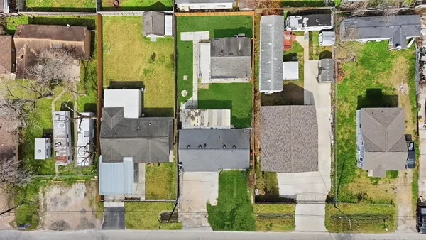aerial view of multiple houses with a yard