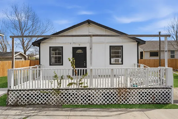 a front view of a house with a wooden fence