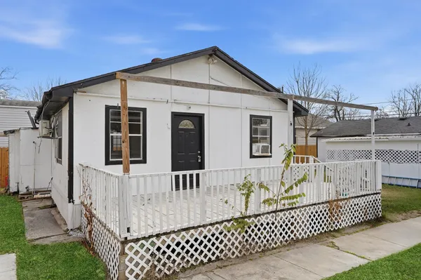 a view of a house with wooden fence