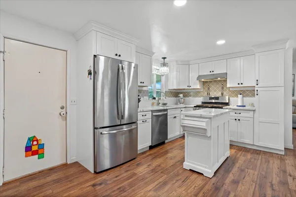 a view of a dining room with furniture and wooden floor