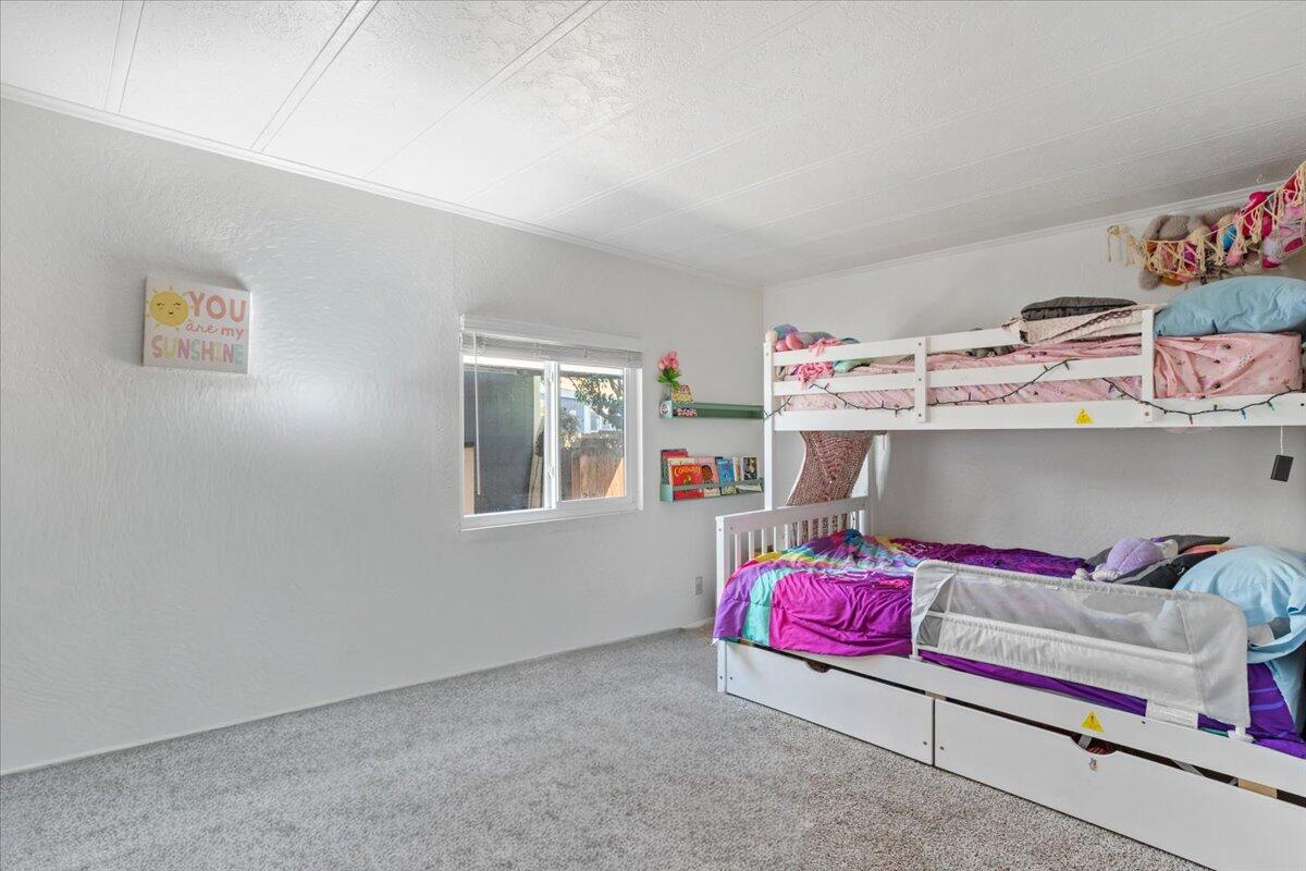 5700 Via Real, Unit 106 Carpinteria, CA 93013 - Photo 18 of 26 a bedroom with a bed and a window