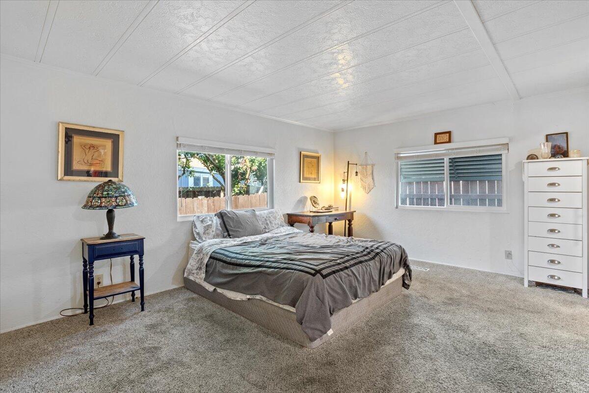 5700 Via Real, Unit 106 Carpinteria, CA 93013 - Photo 20 of 26 a bedroom with a bed and a dresser