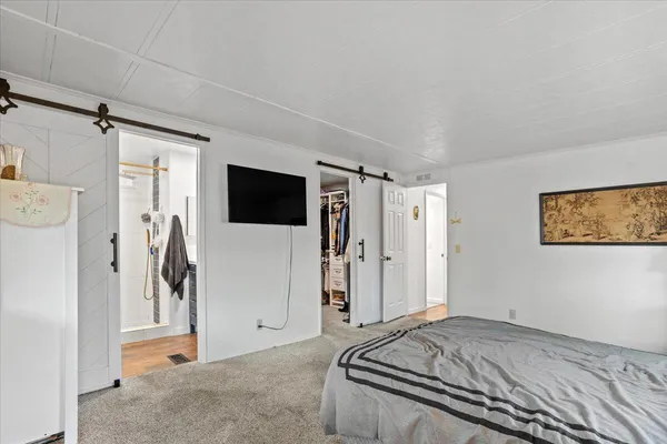 a view of walk in closet with clothes