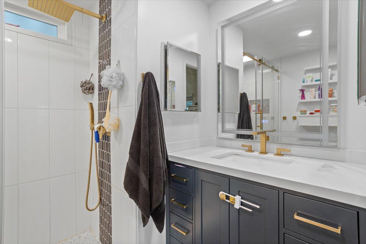 5700 Via Real, Unit 106 Carpinteria, CA 93013 - Photo 23 of 26 a bathroom with a sink vanity and a shower