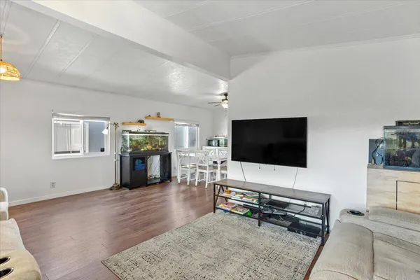 a living room with furniture and wooden floor