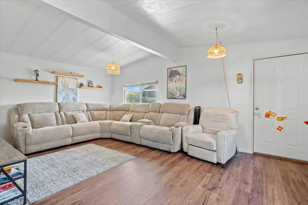 a kitchen with a table chairs refrigerator and microwave