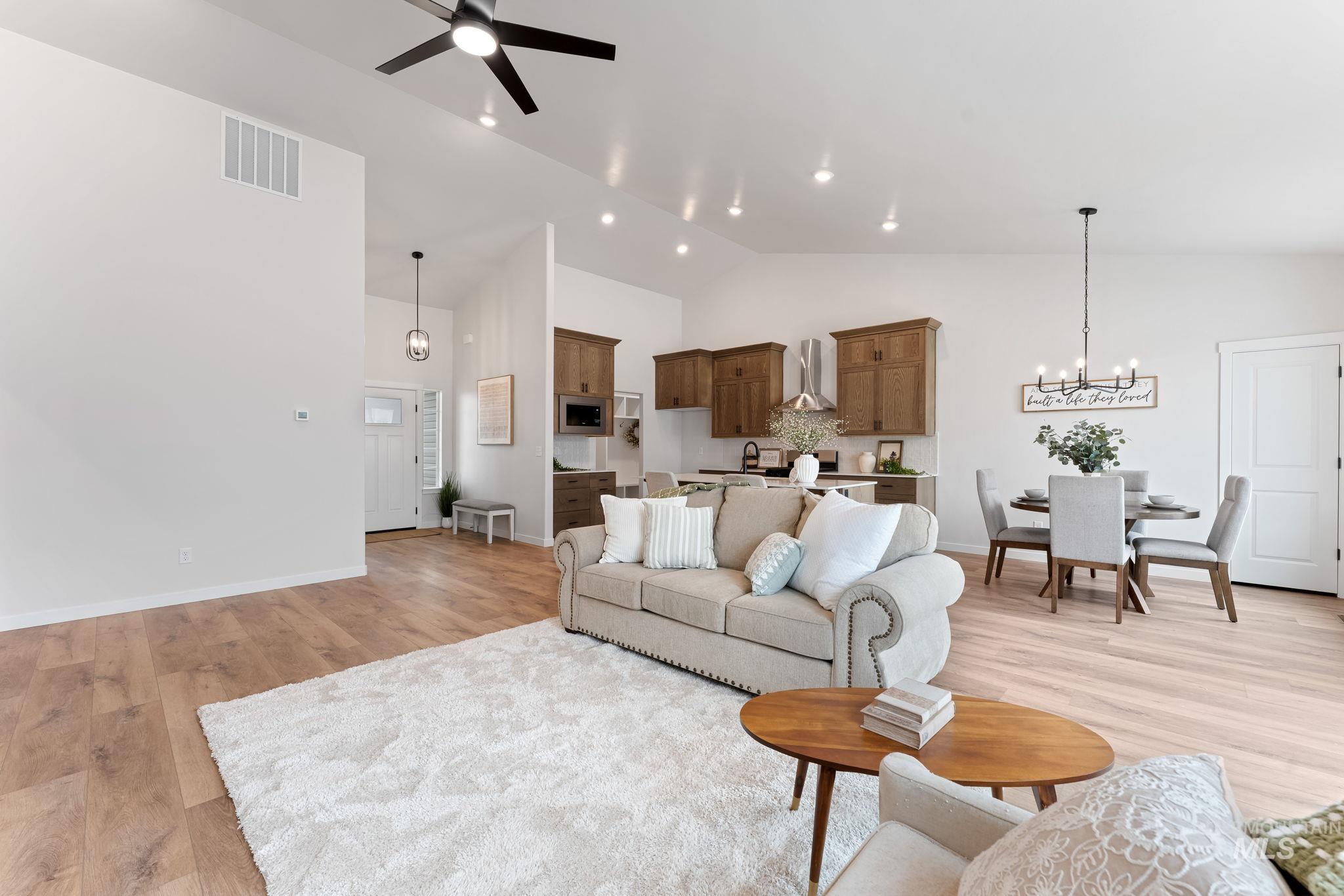 2220 Great Basin Way Burley, ID 83318 - Photo 13 of 39 Living room featuring light wood-type flooring, a ceiling fan, vaulted ceiling, and hanging lights