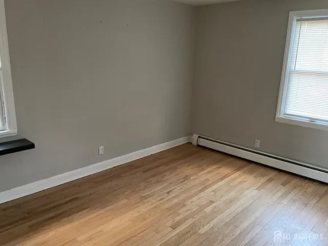 a view of an empty room and wooden floor