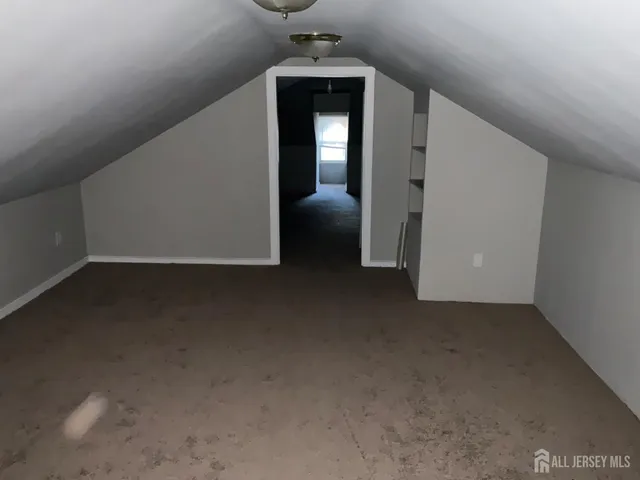 a view of a livingroom with wooden floor and a ceiling fan