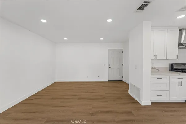 a view of a kitchen with wooden floor