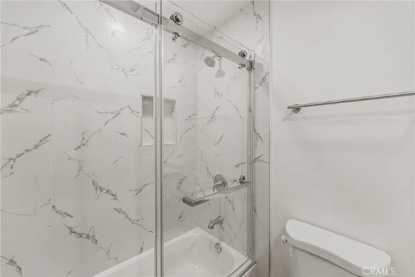 a bathroom with a shower and toilet