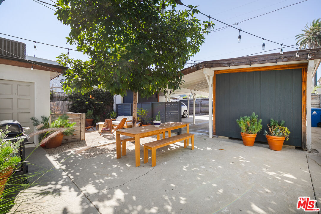 331 Brooks Avenue, Unit 2 Venice, CA 90291 - Photo 22 of 30 a view of a patio with table and chairs potted plants and a large tree