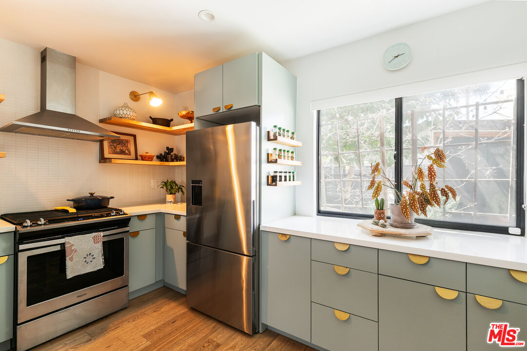 331 Brooks Avenue, Unit 2 Venice, CA 90291 - Photo 8 of 30 a kitchen with stainless steel appliances a refrigerator a stove and wooden cabinets